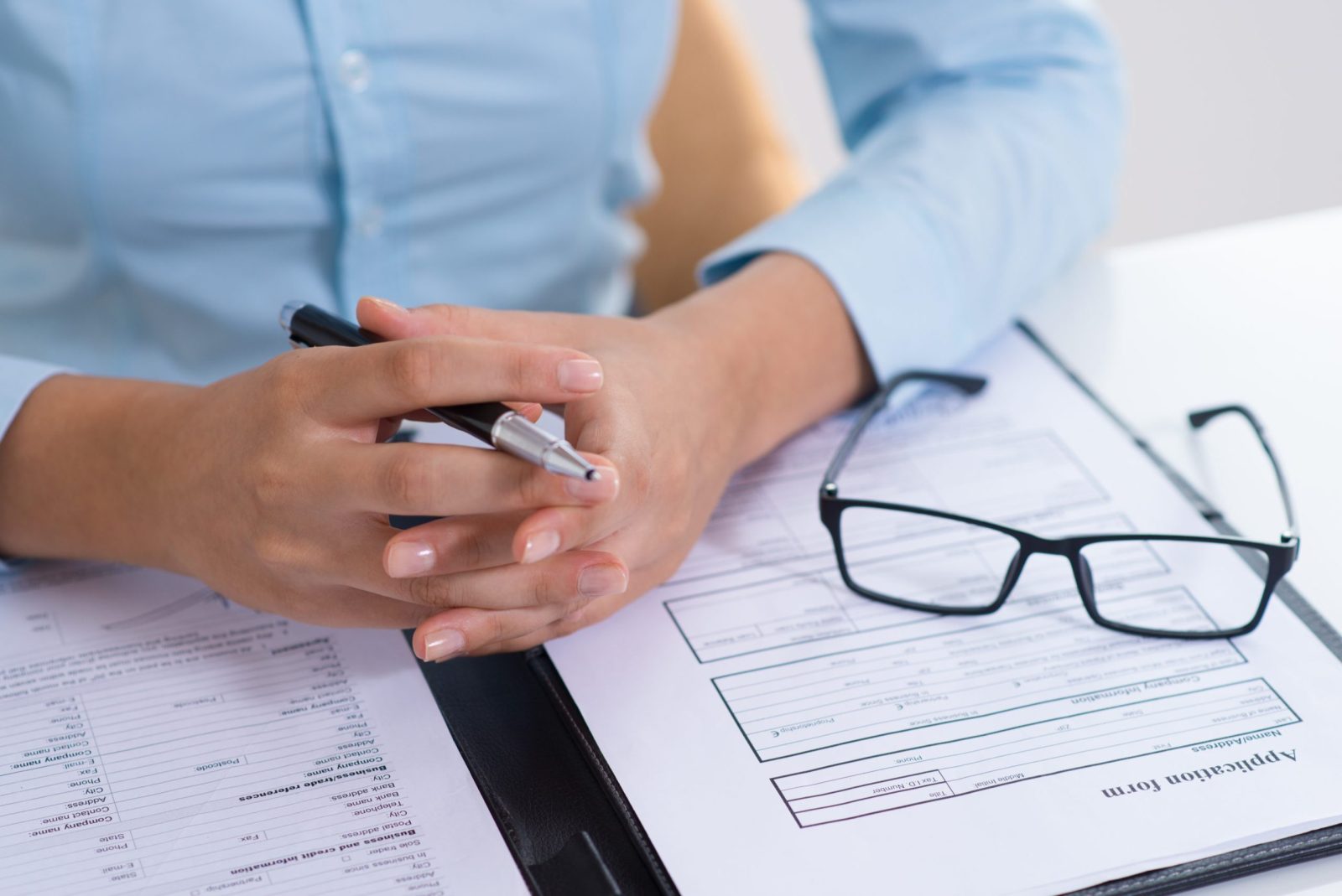 Closeup boss reading filled application form scaled e1769962644334